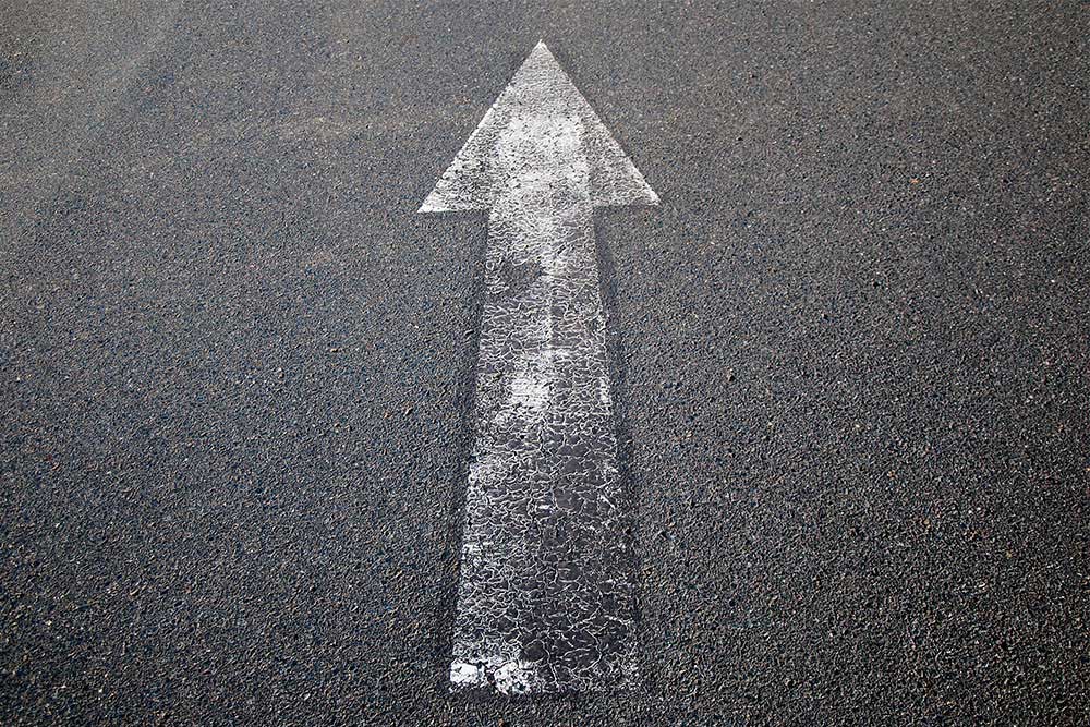 Close up of an asphalt surface with obsolete marking for roughening and demarcation with high-pressure water