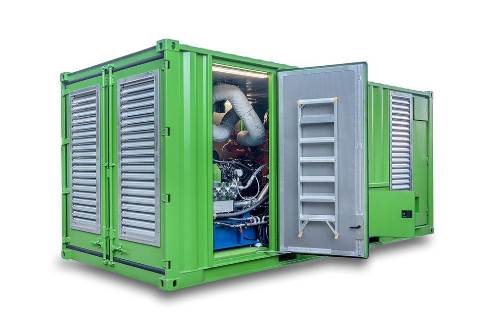 A green container unit photographed from the side, the open door reveals the inner workings of the unit.